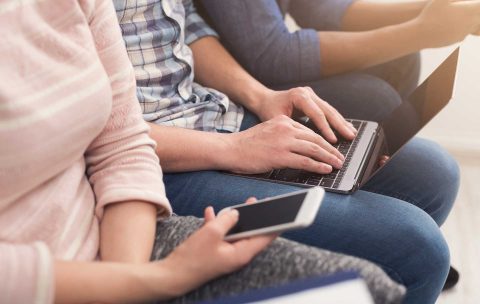 Group of unrecognizable people using gadgets